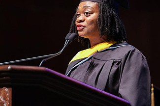 Winnie Ekwegh speaking into a mic on the stadium at gradutation