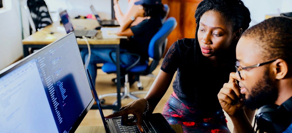 team of data scientists working on computer